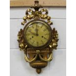 A 20th century Continental giltwood cartel clock with eight day movement striking on a bell, the