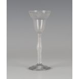 An airtwist stem wine glass, mid-18th century, the pan-topped rounded funnel bowl engraved with a