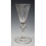 A Dutch engraved soda glass, early 18th century, the rounded funnel bowl engraved with a foliate