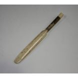 A late 19th century carved bone novelty pencil, modelled in the form of a cricket bat, the handle