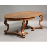 A 20th century French oak extending dining table, the oval top with a single extra leaf, raised on