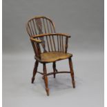 A 19th century yew and elm Windsor armchair with pierced splat back, the solid seat raised on turned