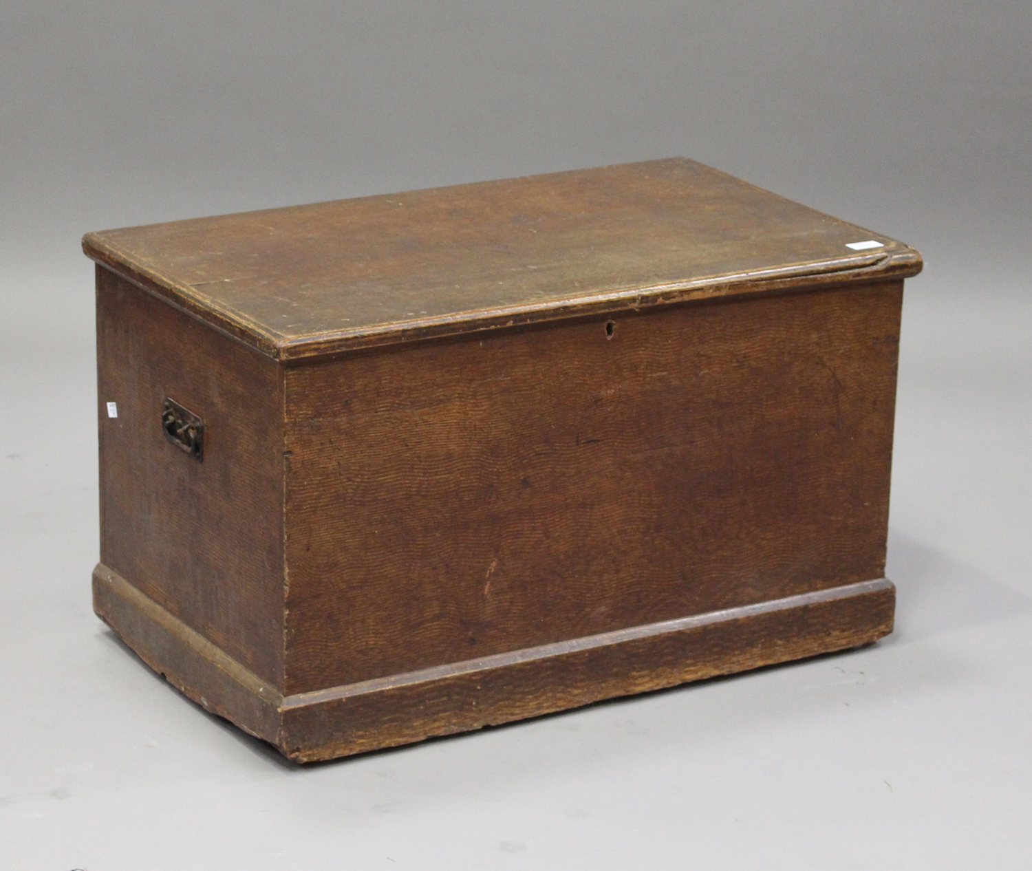 A 19th century scumbled pine trunk, the sides fitted with carrying handles, height 48cm, width