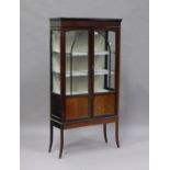 An Edwardian mahogany display cabinet, fitted with a pair of astragal glazed doors, on square