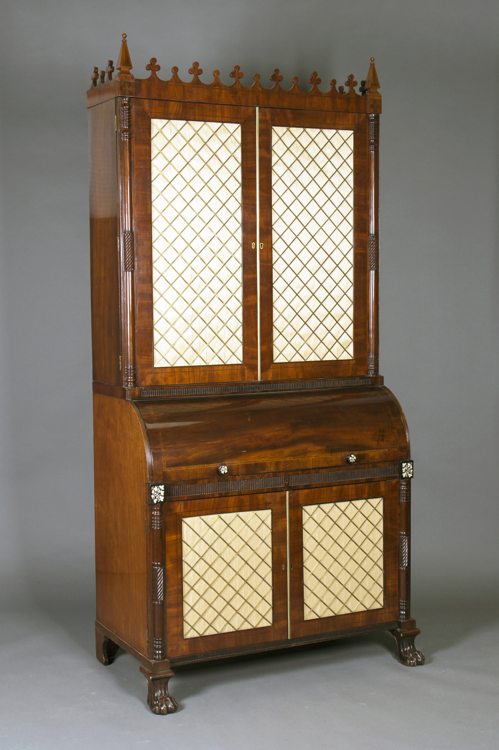 A mid-Victorian Gothic Revival mahogany roll-top bureau bookcase with overall ebony stringing and