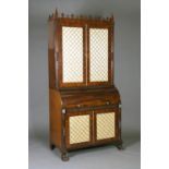 A mid-Victorian Gothic Revival mahogany roll-top bureau bookcase with overall ebony stringing and