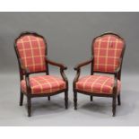 A pair of late 19th century French mahogany showframe armchairs with moulded decoration, the