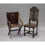 A Victorian walnut 'X' frame chair with carved decoration, the solid seat on block supports,