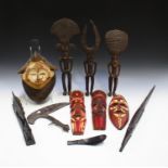 A group of 20th century African items, including three figures, a carved and painted mask, a