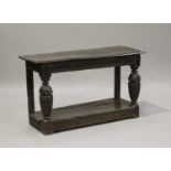 A 17th century and later oak console table, the rectangular top above a frieze with carved linenfold