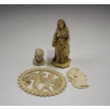 A 19th century Dieppe ivory figure of a standing nun, height 8cm, a 19th century carved ivory