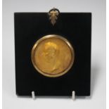 A 19th century gilded cast metal portrait medallion of William Pitt, inscribed 'Gvlielmo Pitt R.P.