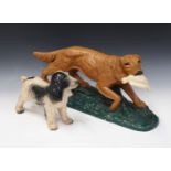 An early 20th century painted plaster model of a gun dog retrieving a bird, length 57cm, together