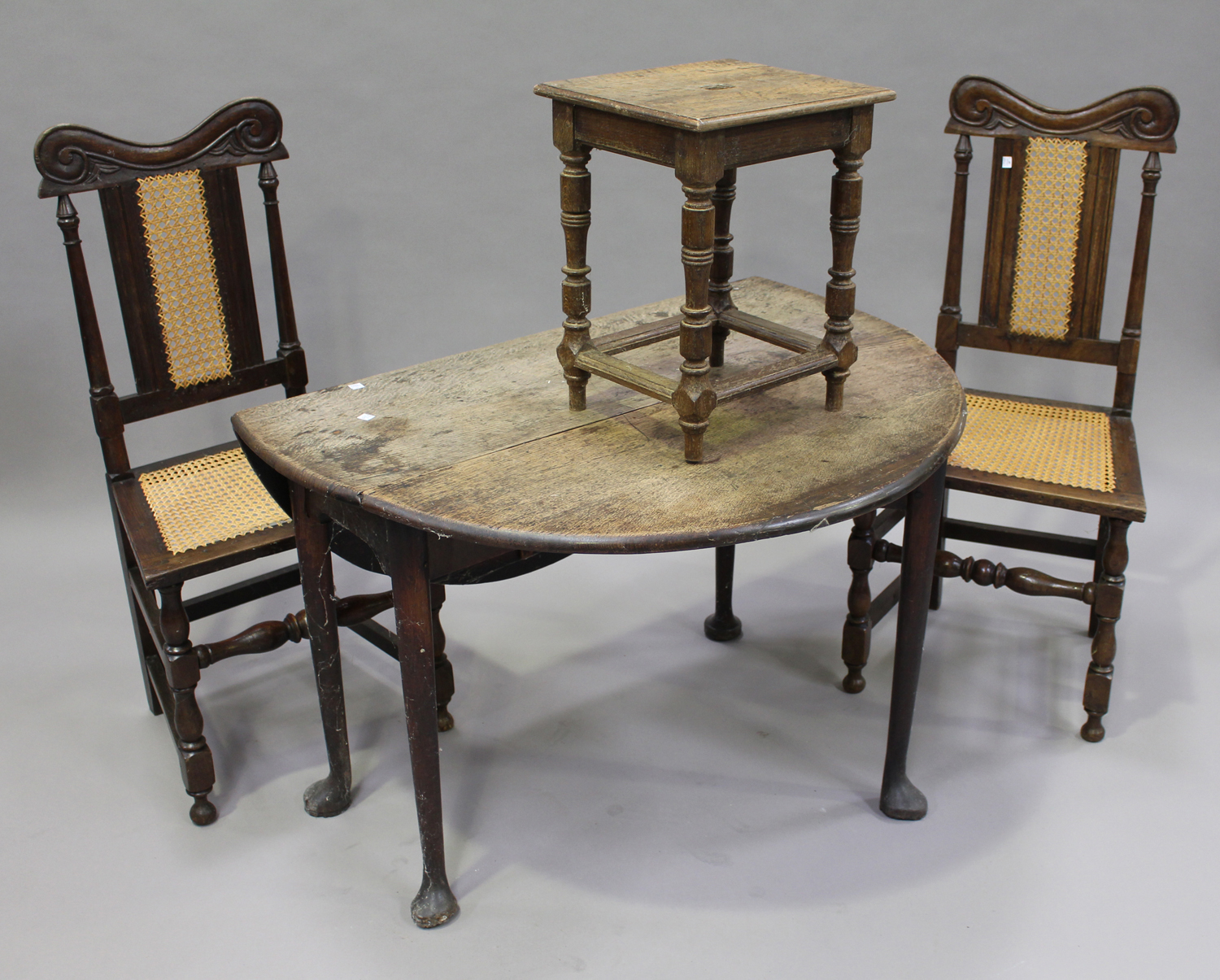 A set of four 19th century Carolean Revival oak dining chairs with carved decoration, the cane seats - Image 2 of 2