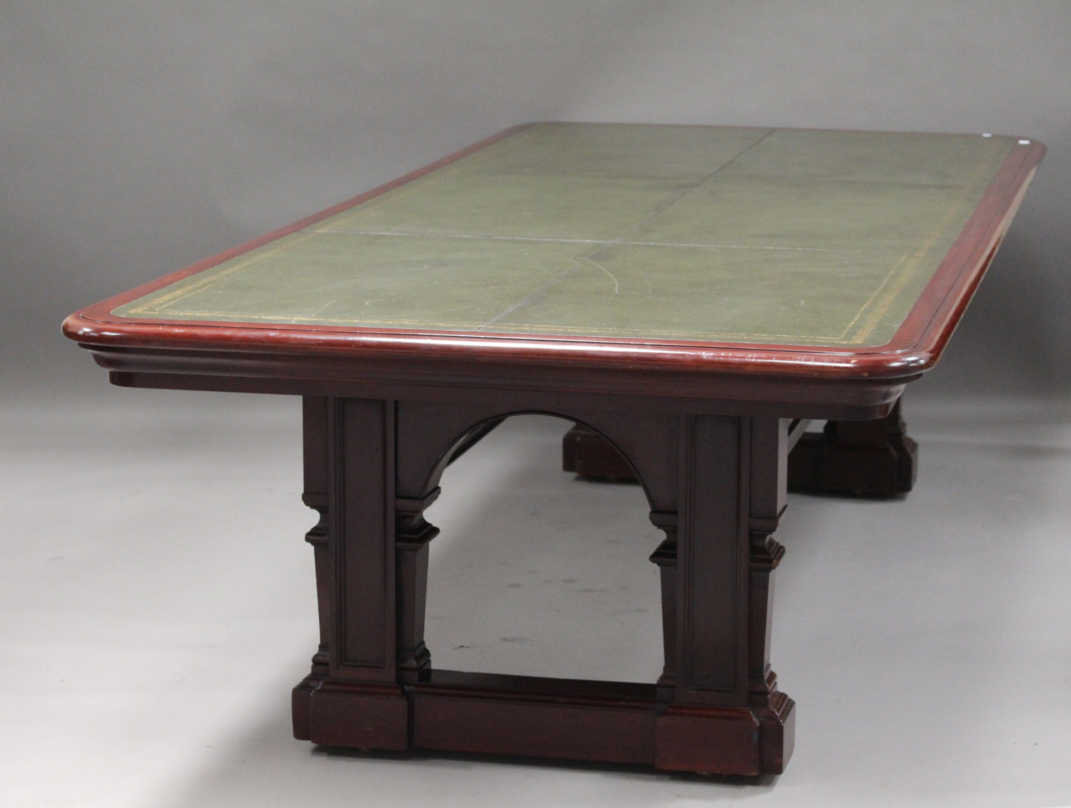 A large late Victorian mahogany library table, the moulded top inset with gilt-tooled green leather,