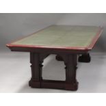 A large late Victorian mahogany library table, the moulded top inset with gilt-tooled green leather,