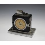 An Art Deco Ronson chromium plated and black finished touch-tip table lighter timepiece, raised on a