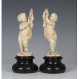A pair of late 18th/early 19th century Continental carved ivory figures of putti, one modelled