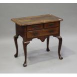 A George II walnut lowboy with boxwood stringing, the moulded edge above two short and one long