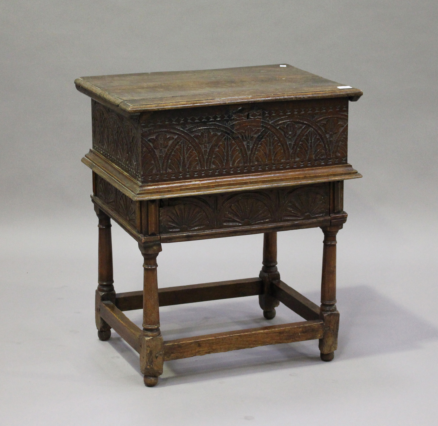 A 17th century and later oak bible box on stand with carved decoration, the hinged lid above the