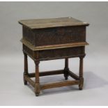 A 17th century and later oak bible box on stand with carved decoration, the hinged lid above the