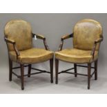 A pair of 20th century George III style tan leather and mahogany framed armchairs, the arched