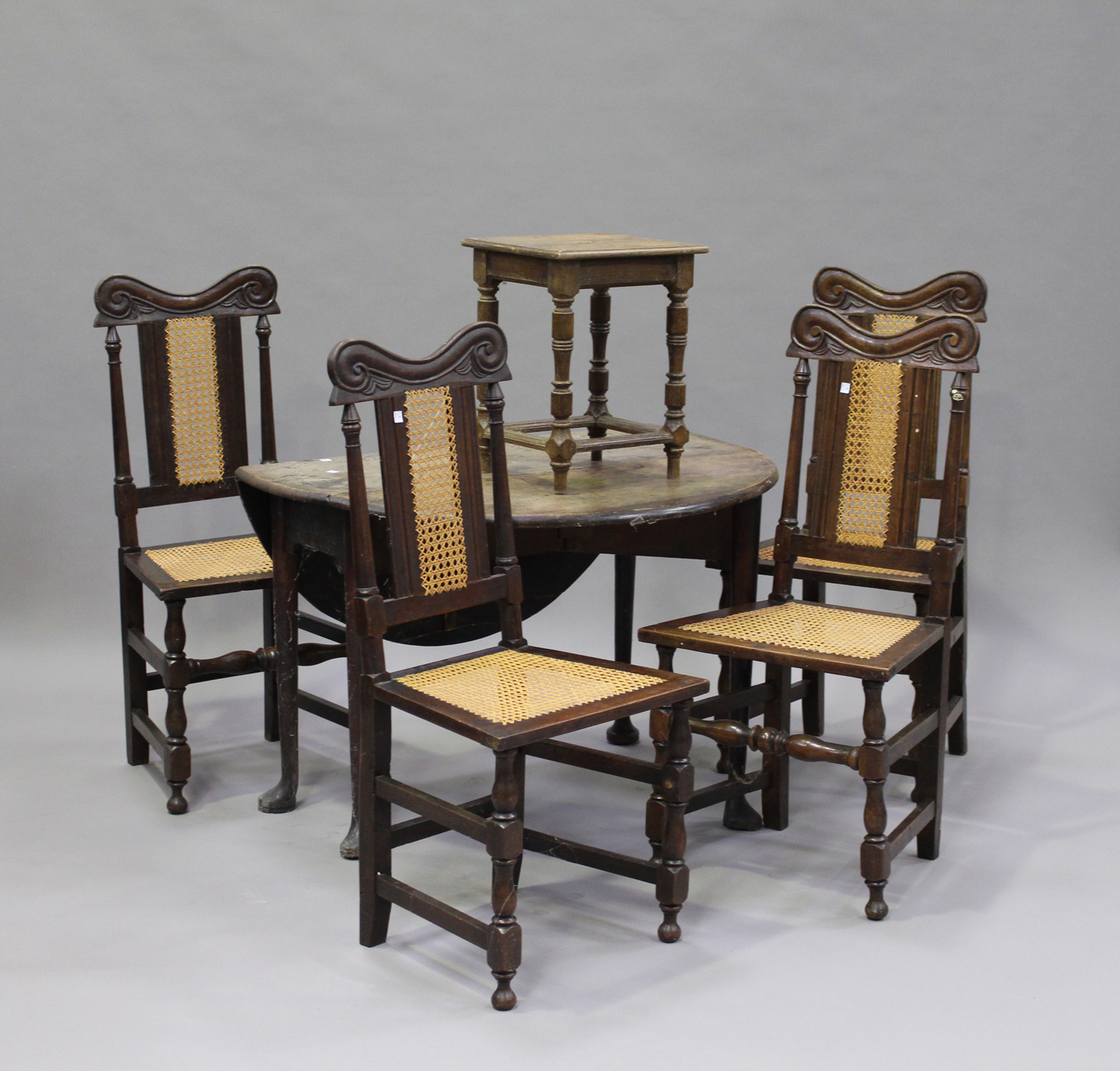 A set of four 19th century Carolean Revival oak dining chairs with carved decoration, the cane seats
