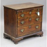 A George II oak bachelor's chest, the crossbanded top above a brushing slide and three crossbanded