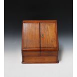 A late Victorian mahogany slope front stationery box, the double-hinged lid enclosing a letter