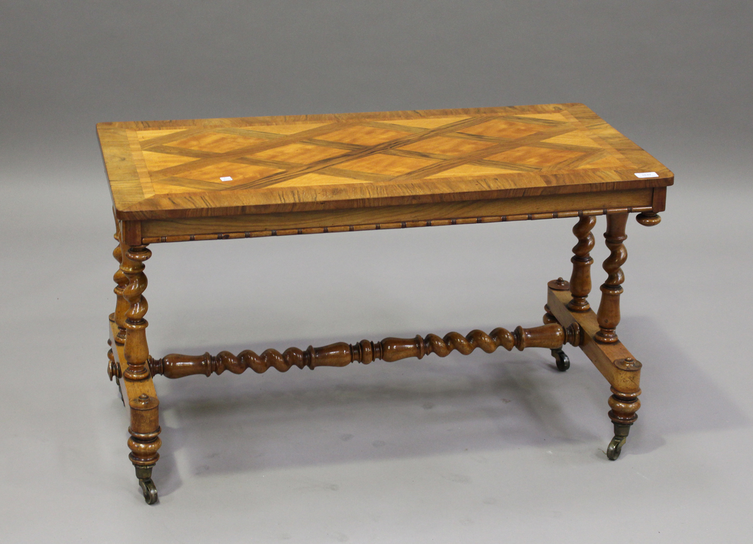 A Victorian walnut and satinwood crossbanded stretcher table, the rectangular top raised on barley