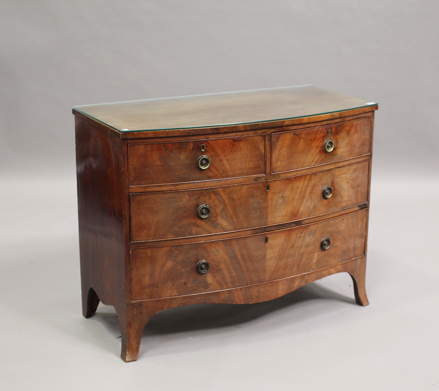 A late George III mahogany bowfront chest of two short and two long drawers, on bracket feet, height