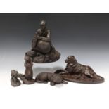 A. Martin - a modern bronzed cast composition model of a recumbent dog, the oval base bearing cast