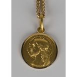 A gold devotional pendant, the obverse depicting a portrait of Christ, detailed '750', length 2.5cm,