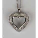 A white gold and diamond open heart shaped pendant, mounted with tapered baguette cut diamonds