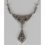 An 18ct white gold and diamond necklace in a pierced crescent shaped design with a pierced drop