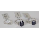 A silver, sapphire and colourless topaz set ring, a silver and diamond set cluster ring, a silver,