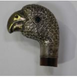 A George V silver novelty parasol handle in the form of a parrot's head with green glass eyes,