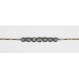 A diamond bracelet, the front collet set with a row of seven graduated cushion shaped diamonds