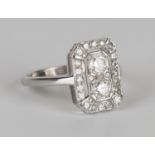 A white gold and diamond rectangular panel shaped ring, mounted with two principal circular cut