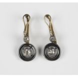 A pair of diamond two stone pendant earrings, each collet set with the principal cushion shaped