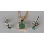 A gold and emerald single stone pendant, claw set with a cut cornered rectangular step cut