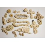 A collection of 19th century carved ivory and bone jewellery, including three pendant crosses, a