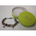 A Chamilia silver charm bracelet, the Brazil link chain fitted with a variety of sliding charms,