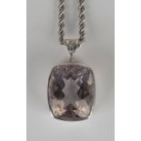 A 9ct white gold, morganite and diamond pendant, collet set with a rectangular cushion shaped pink
