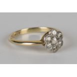 A gold and diamond seven stone cluster ring, mounted with cushion shaped diamonds, detailed '