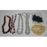 A single row necklace of amethyst and carved rose quartz beads, length 39cm, a single row necklace