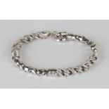 An 18ct white gold bracelet in a textured and alternating polished multiple link design, on a