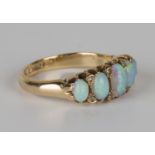 An 18ct gold, opal and diamond ring, mounted with a row of five graduated oval opals and four