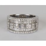 An 18ct white gold and diamond ring, mounted with baguette and circular cut diamonds in a five row