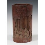 A Chinese bamboo brush pot, early 20th century, carved and pierced with sages in a bamboo grove,